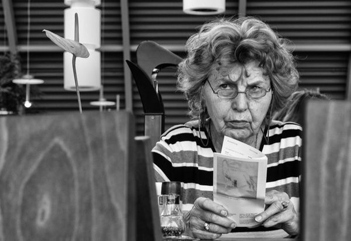 Older Lady Reading Looking Concerned